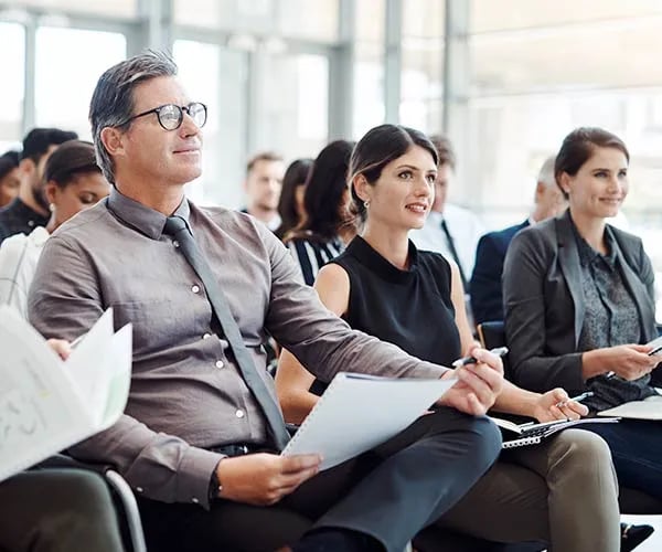 A group of team members eagerly receive a presentation