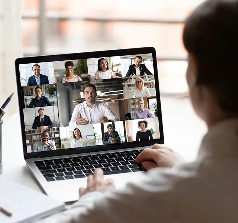 A team talks on a computer via a video conference